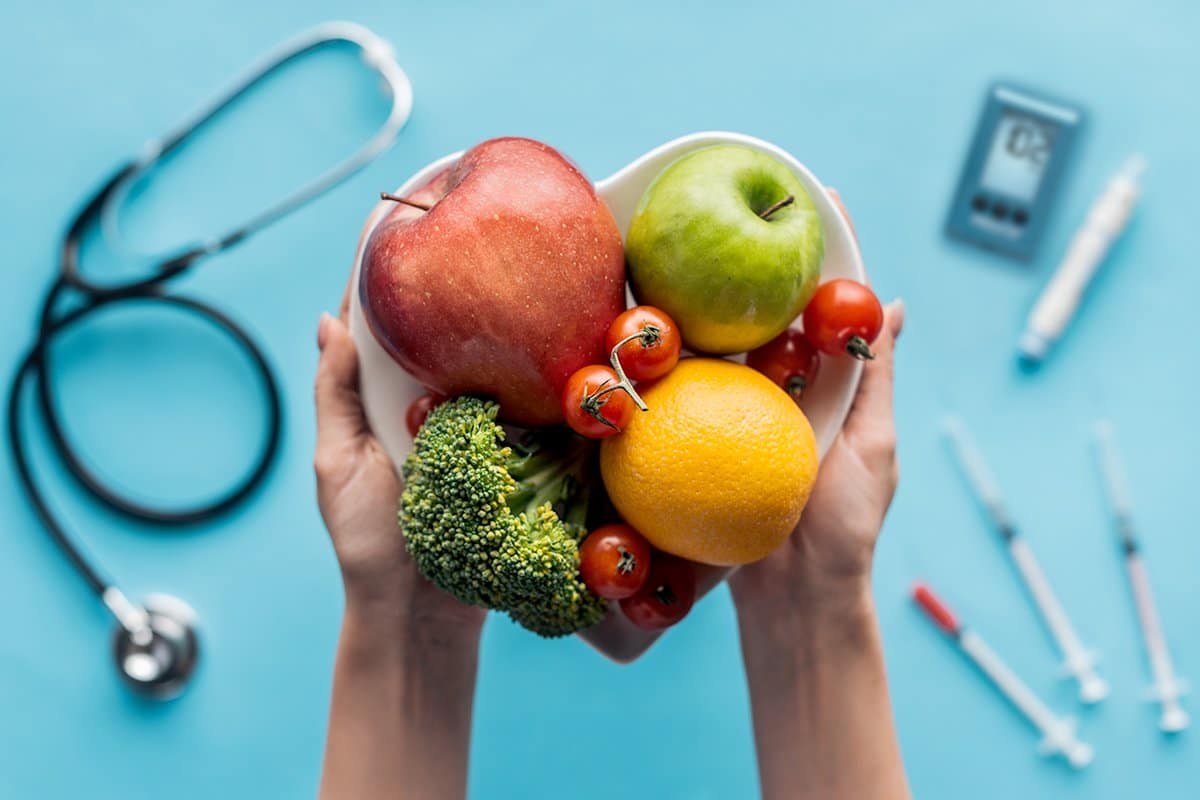 hand-holding-healthyfood-with-medical-tools